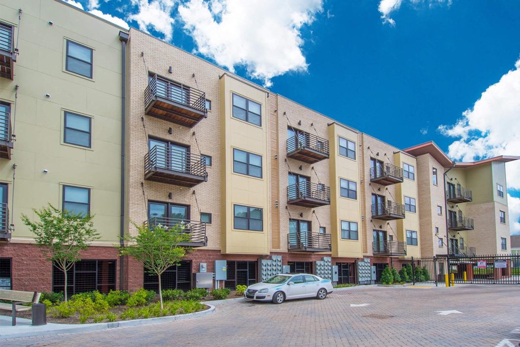 a car parked in front of an apartment building