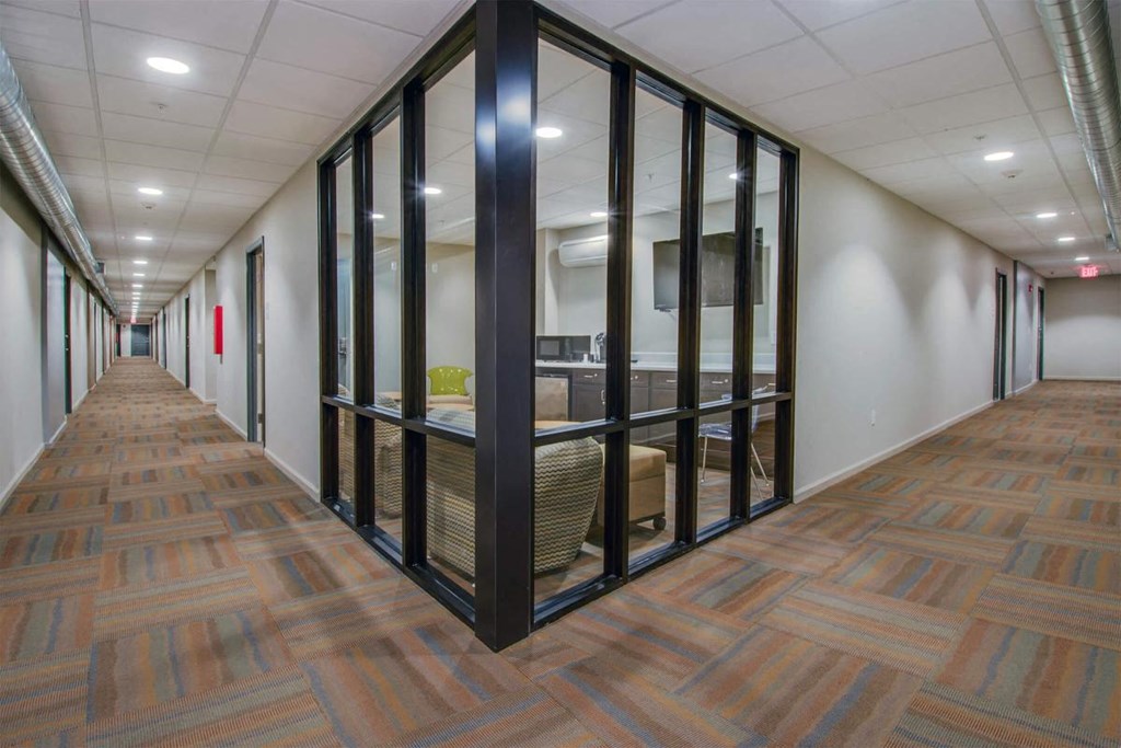 a hallway with glass doors in a office building