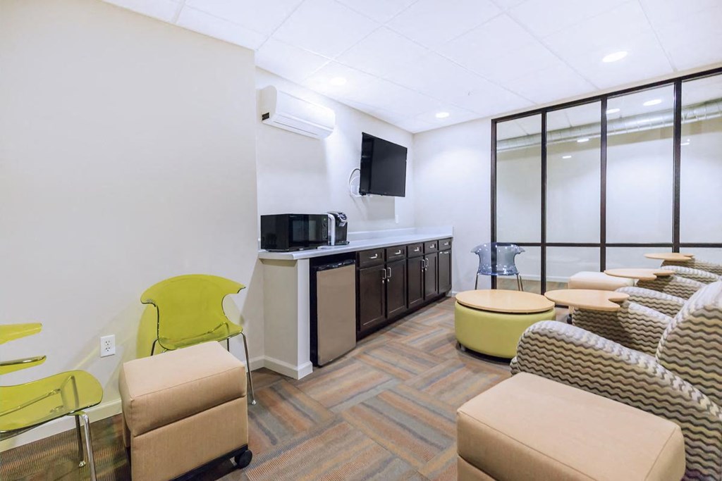 a living room with couches and chairs and a television