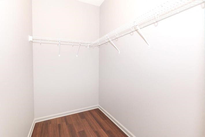 an empty room with white walls and a wood floor
