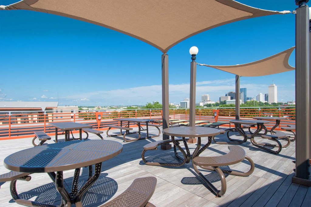patio with tables and chairs and a view of the city