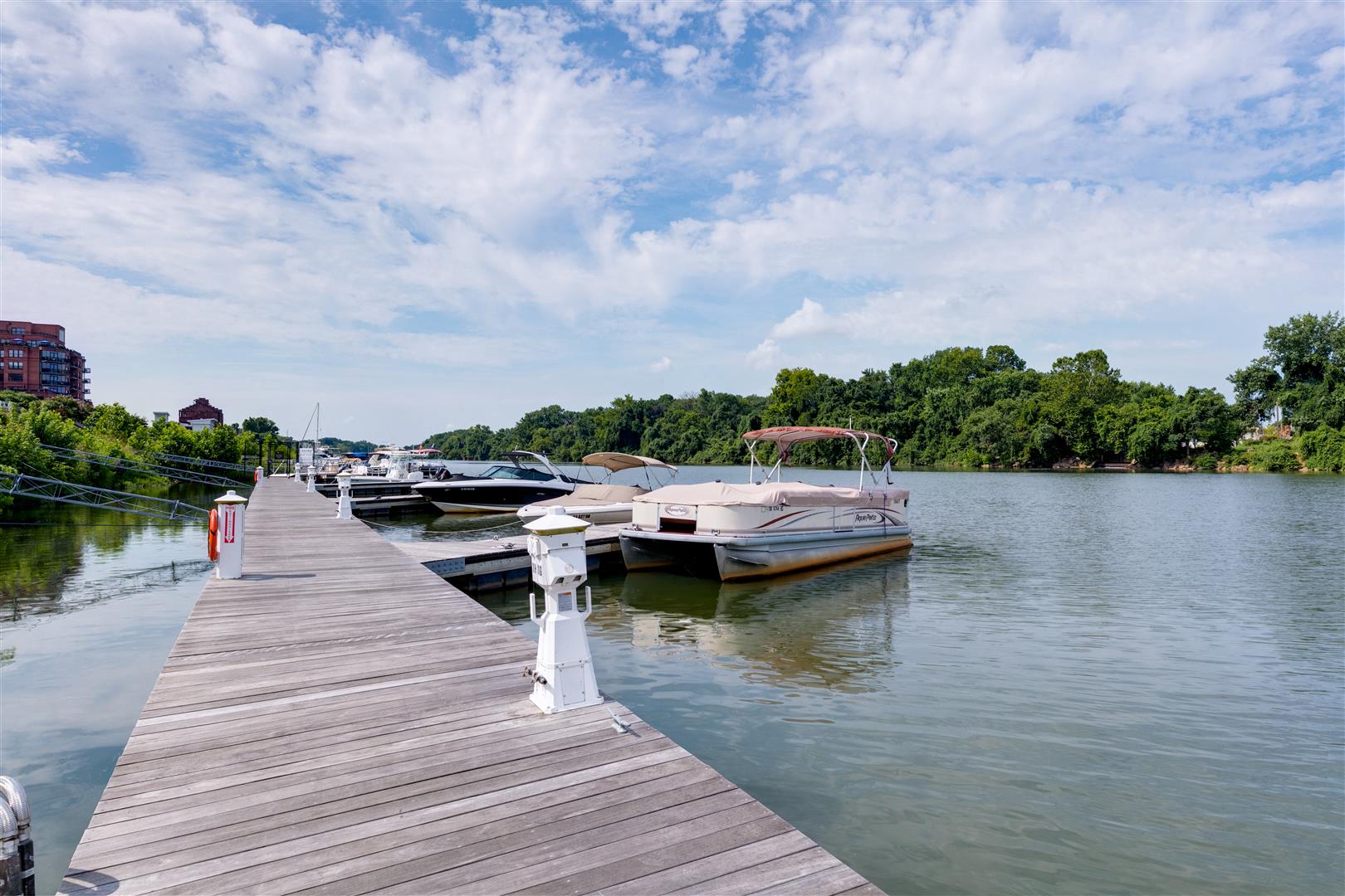 a row of boats docked at a dock on the water