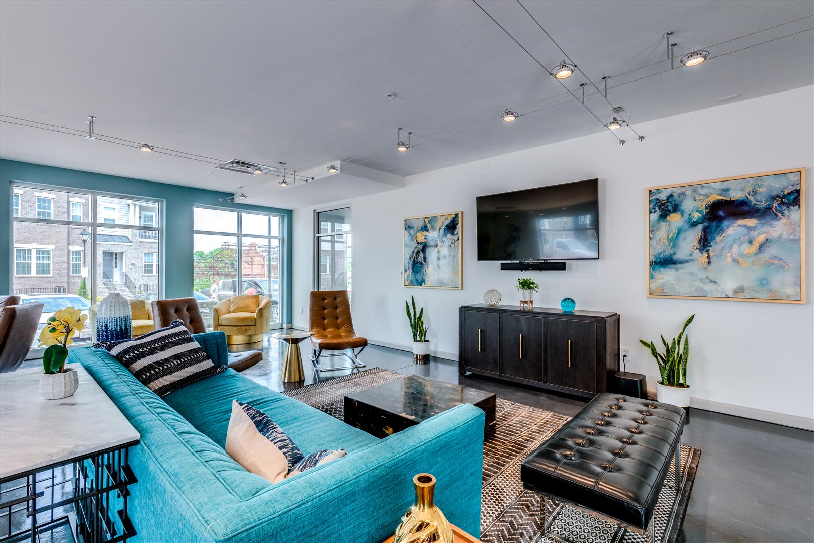 a living room with a blue couch and a television