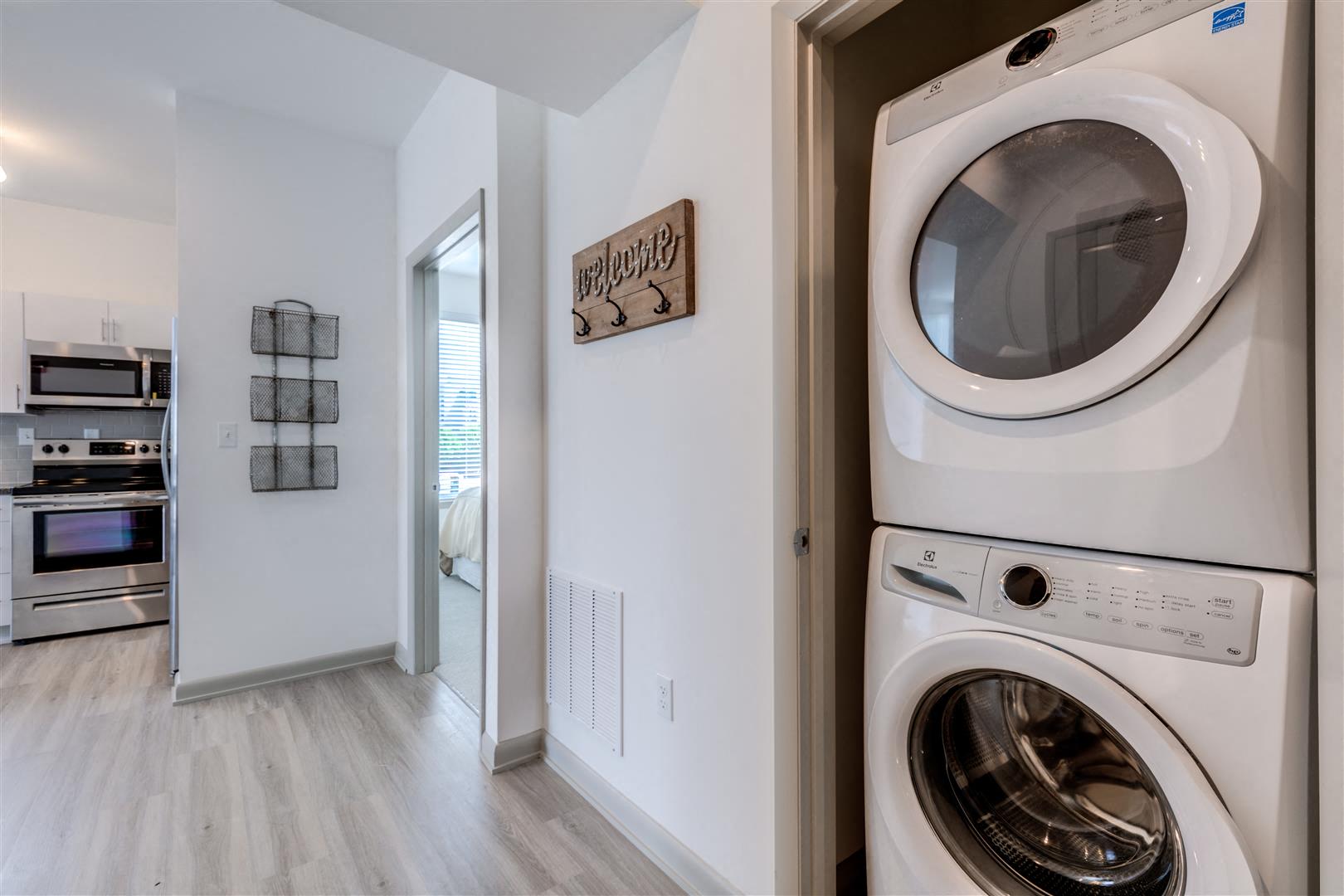 a white washer and dryer in a laundry room with a door