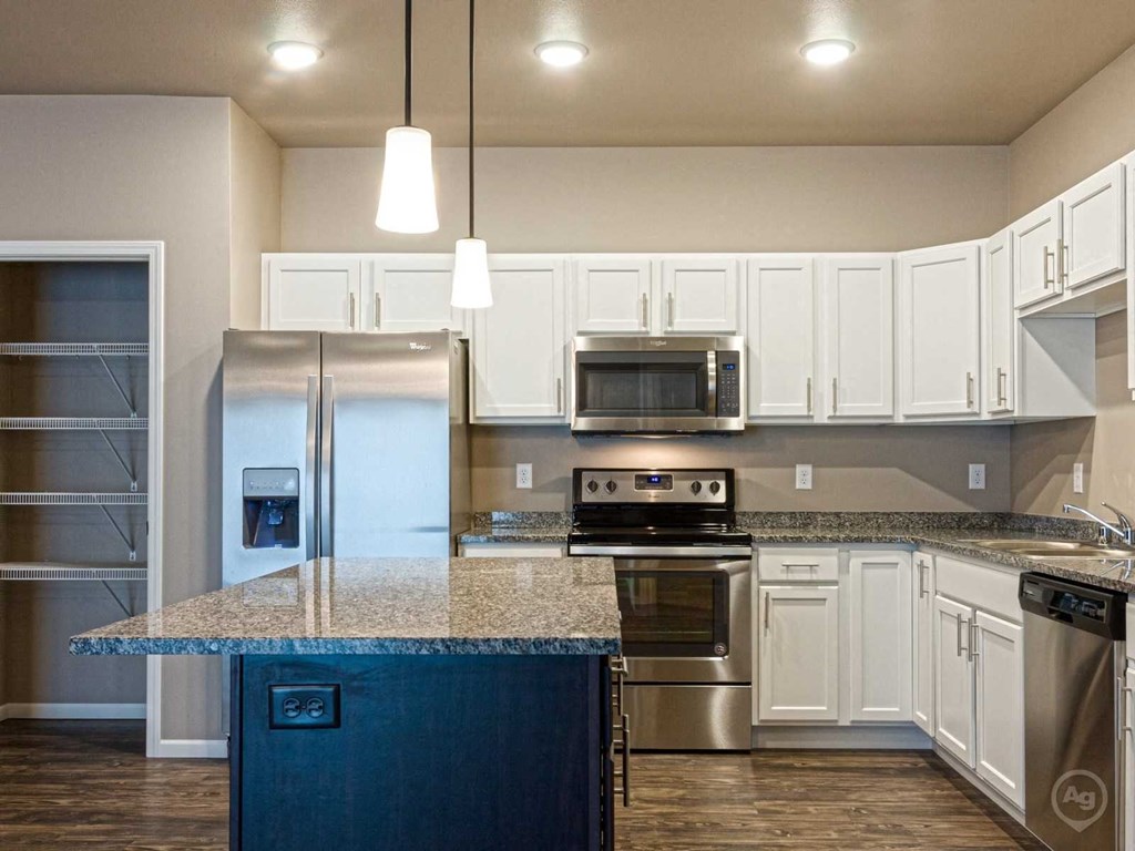 a kitchen with stainless steel appliances and a granite counter top