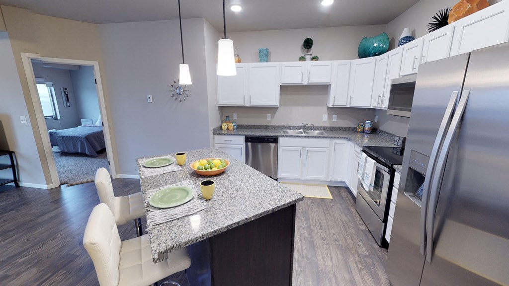 a kitchen with stainless steel appliances and a granite counter top