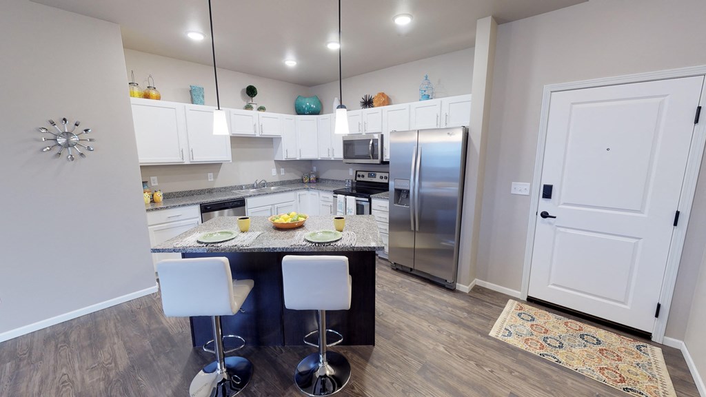 a kitchen with stainless steel appliances and a marble counter top