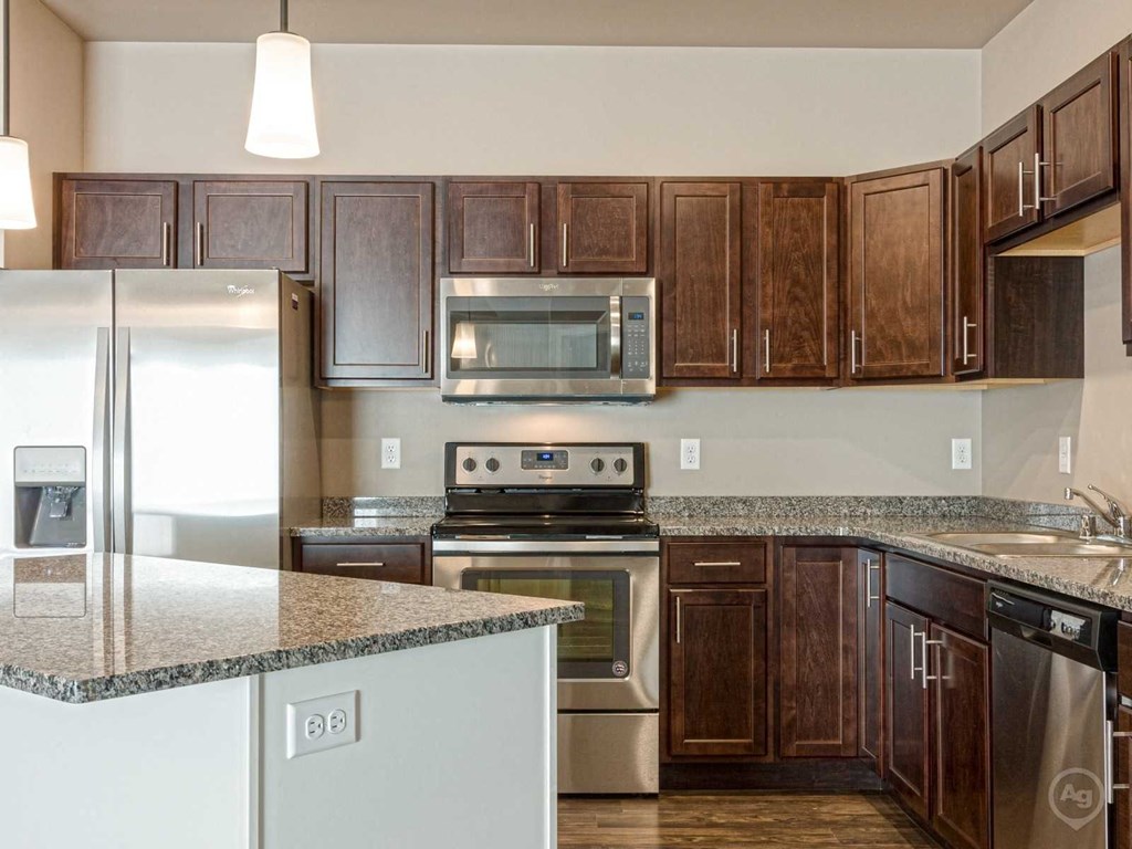 a kitchen with stainless steel appliances and granite counter tops
