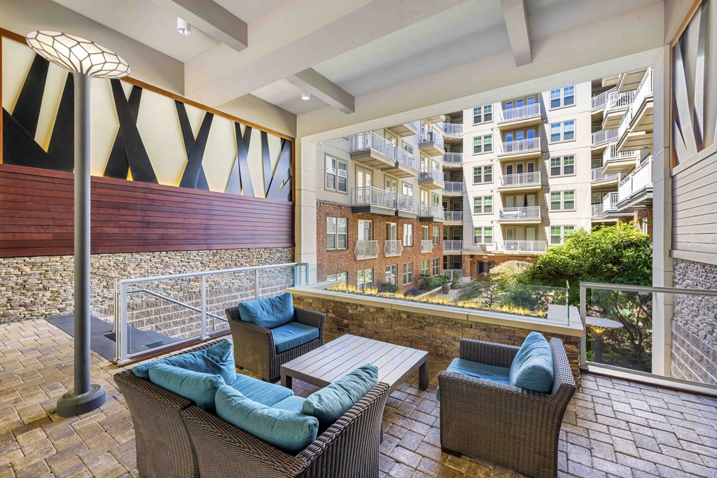 a patio with a table and wicker furniture