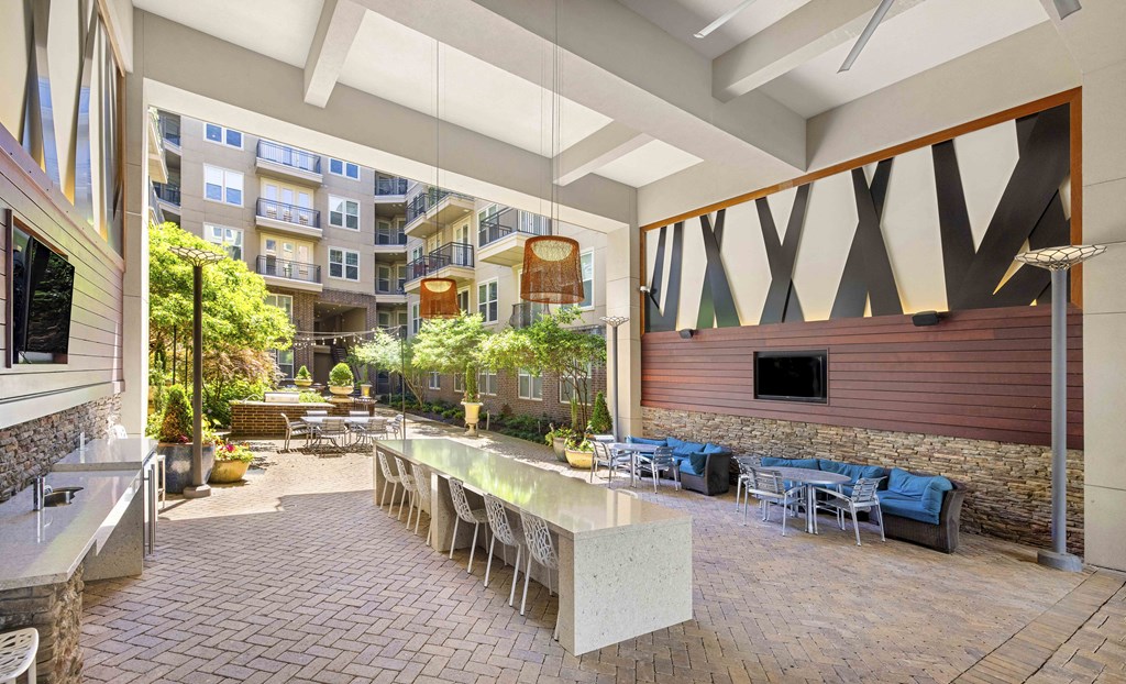 a communal area with tables and chairs and a bar