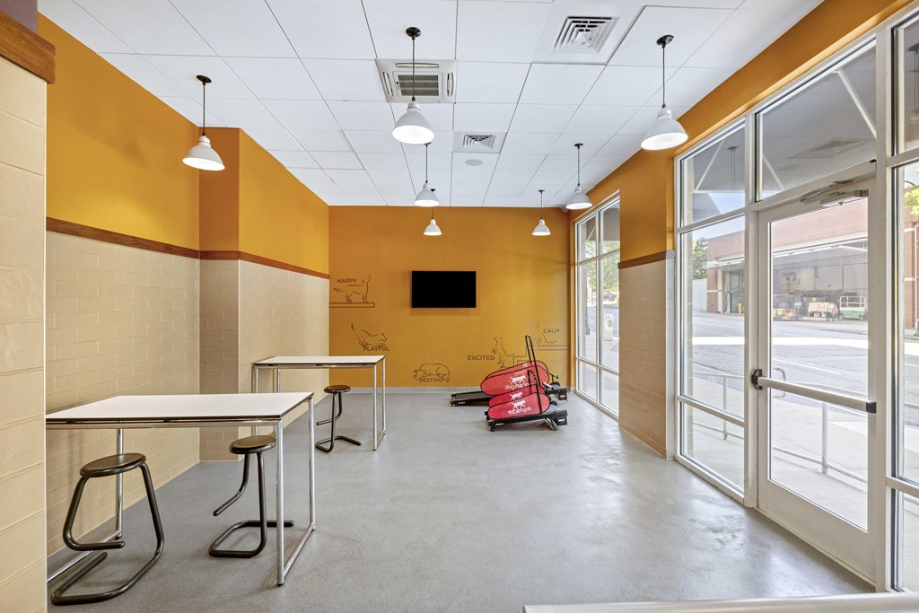 a room with a table and chairs and a red moped