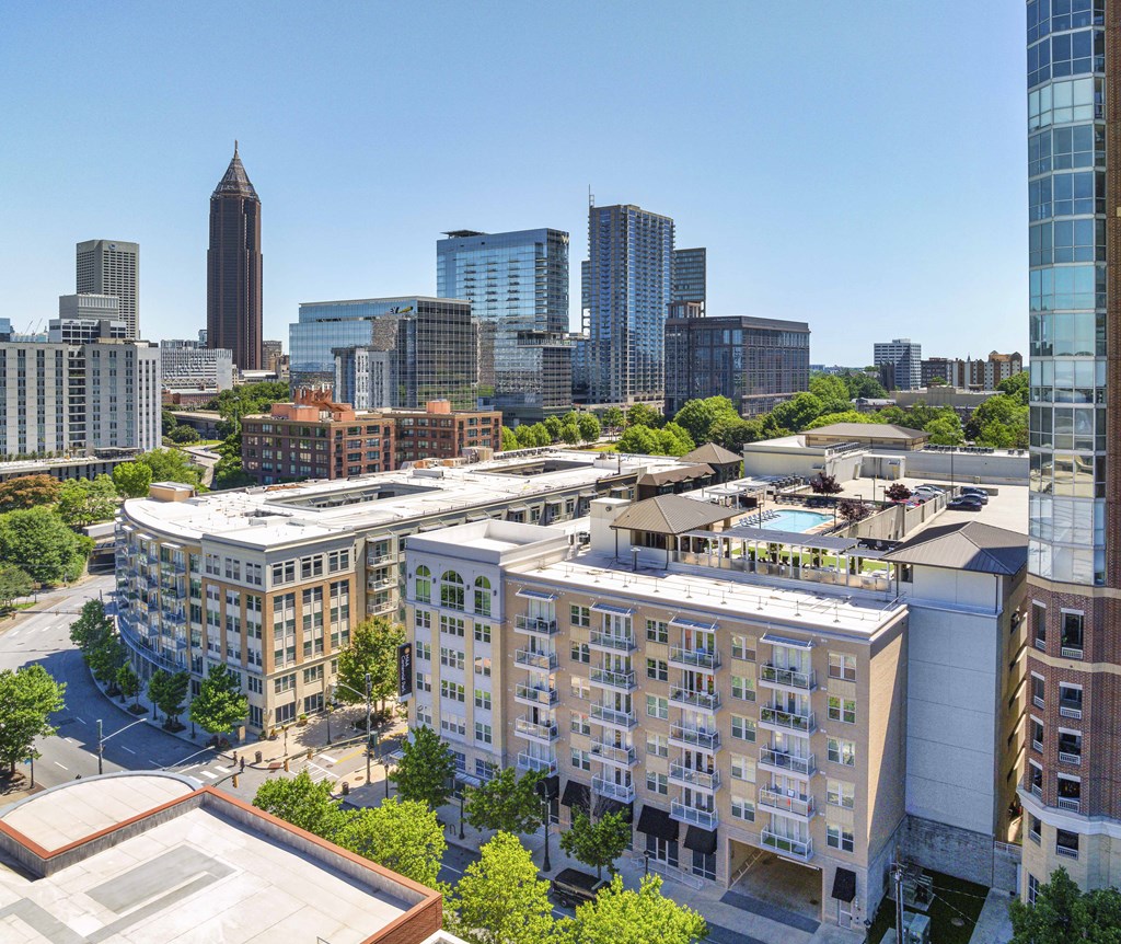 an aerial view of a city with tall buildings and trees