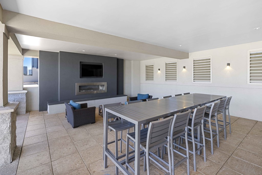 a long table and chairs in a room with a fireplace