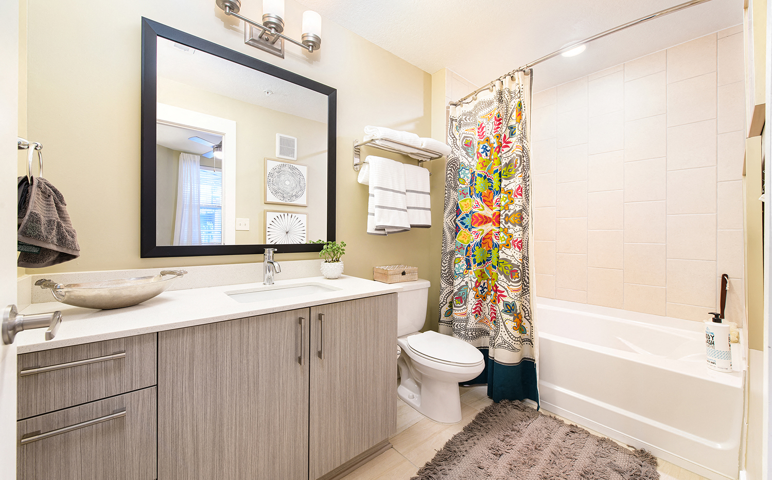 a bathroom with a shower toilet and sink and a mirror