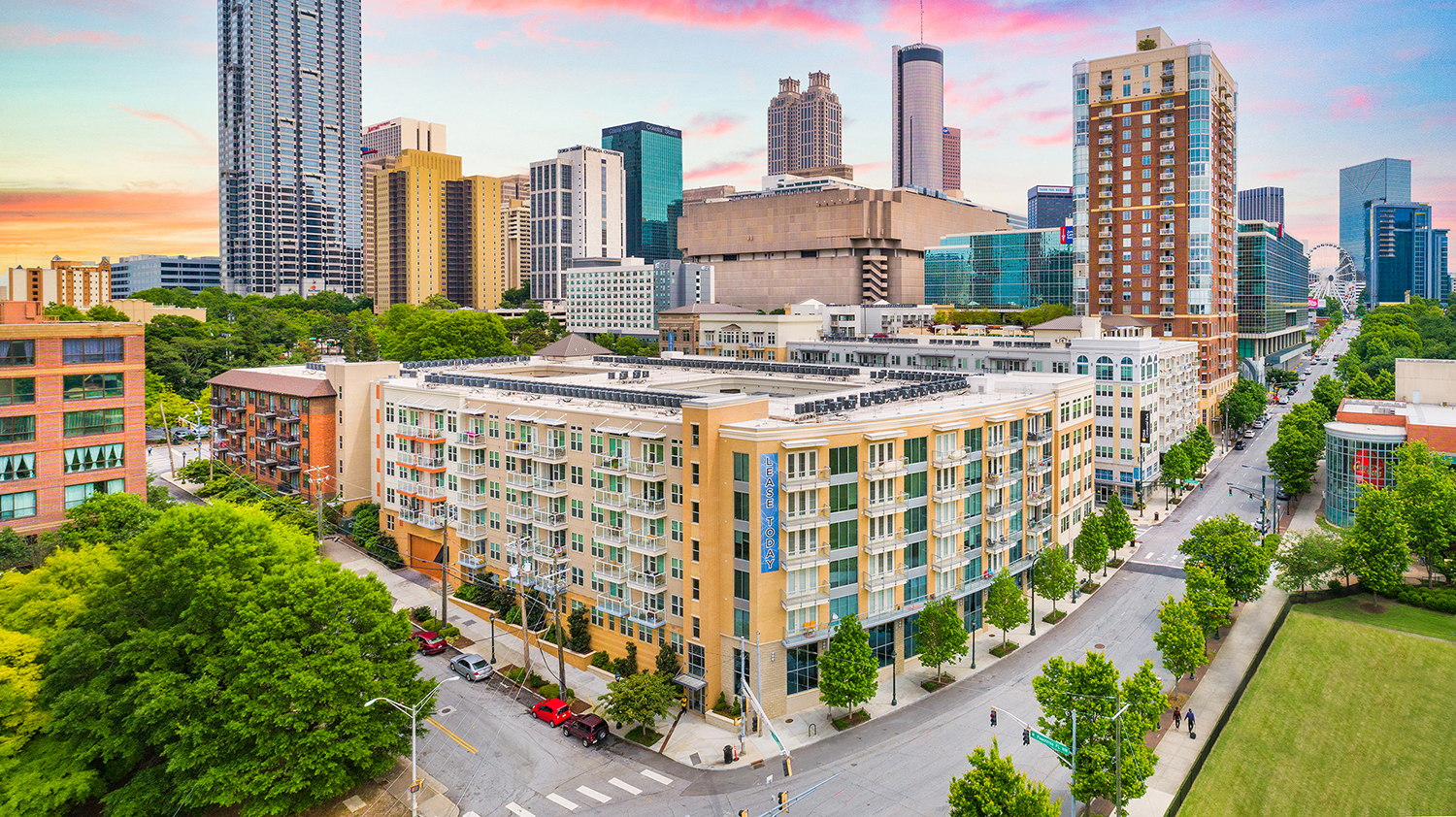 an aerial view of a building with a city in the background