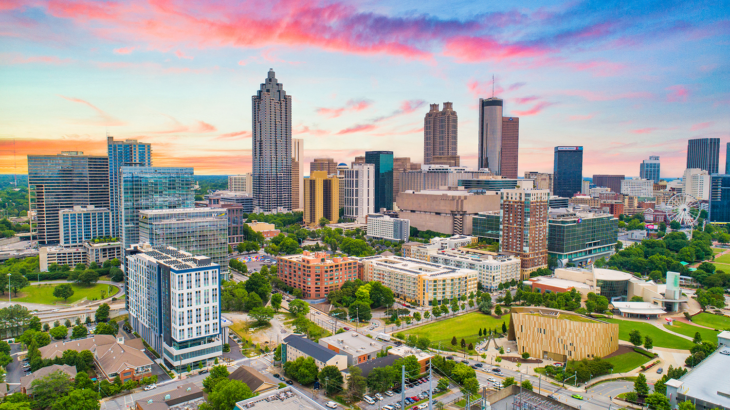 an aerial view of the city at sunset