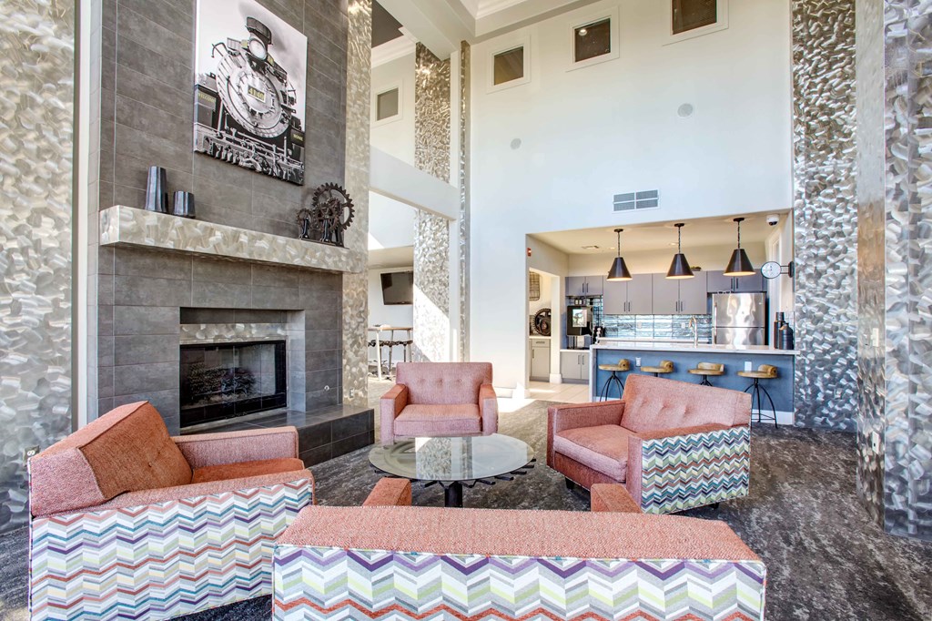 a living room with couches and chairs and a fireplace