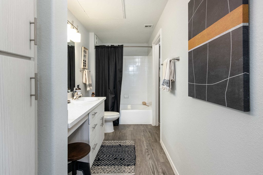 a bathroom with a shower and a sink and a toilet