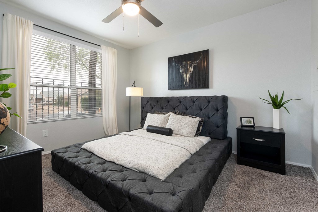 a bedroom with a bed and a ceiling fan