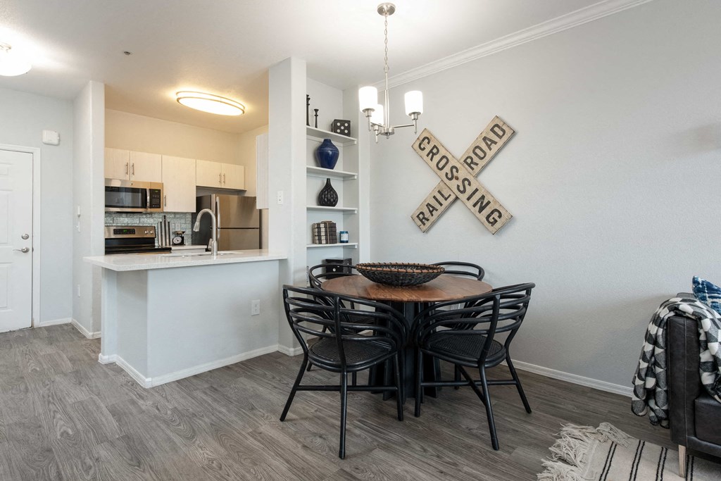 a dining room with a table and chairs and a kitchen