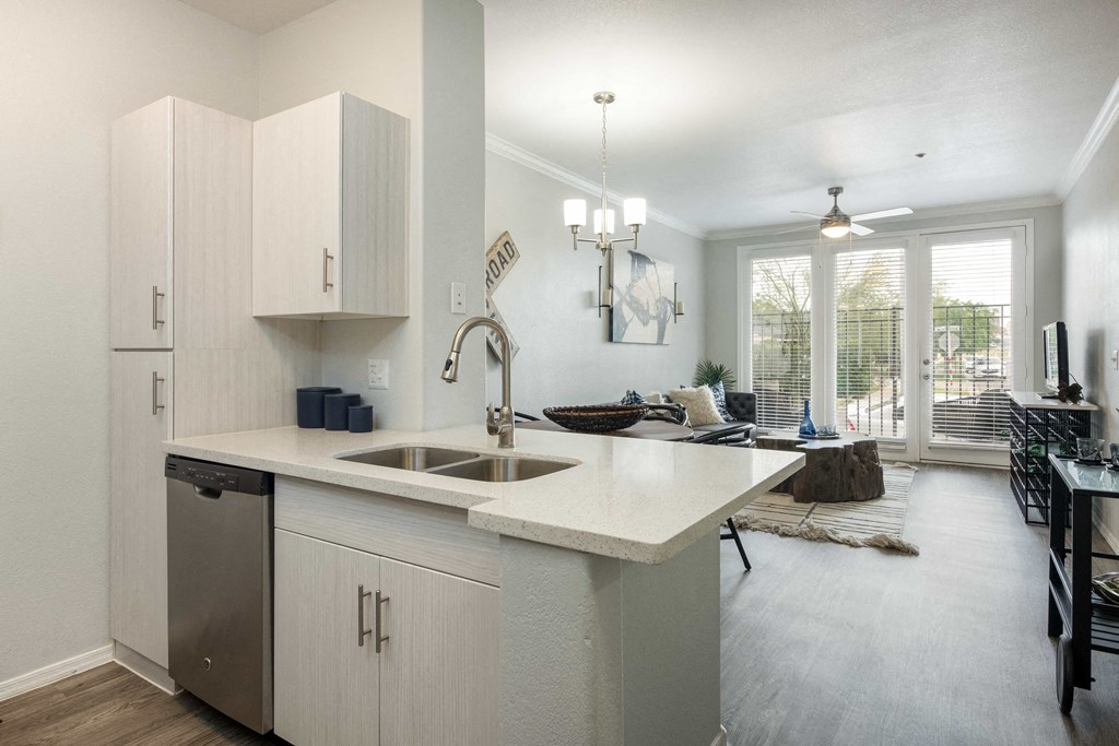 an open kitchen and living room with a view of a living room