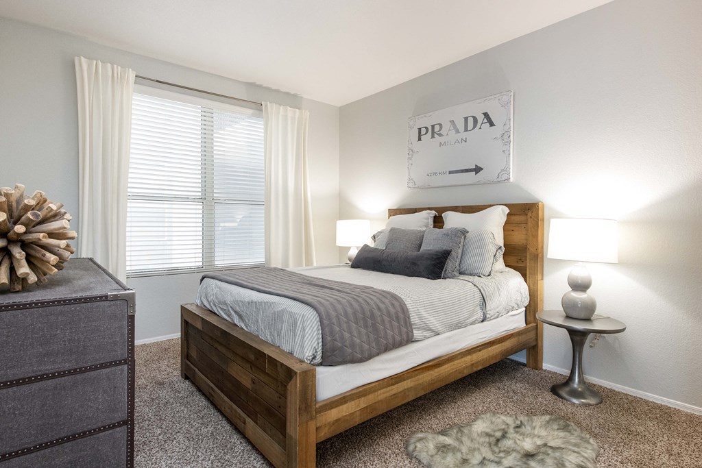 a bedroom with a bed and a large window