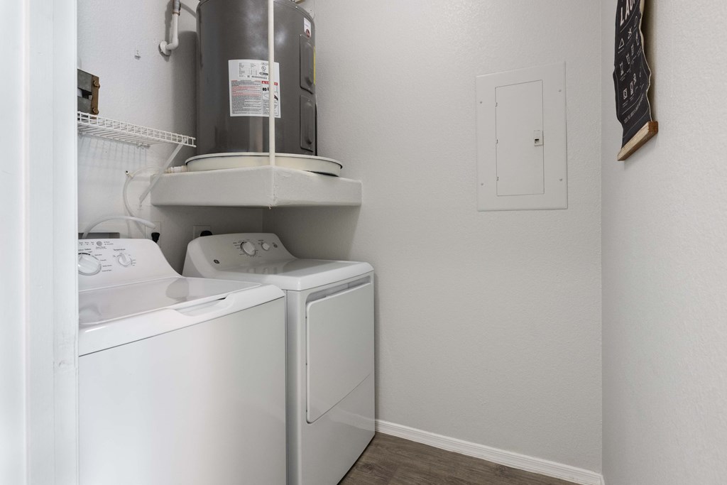 a laundry room with a washer and dryer and a sink and a refrigerator