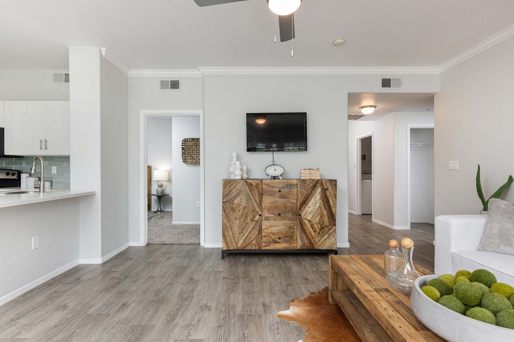 a living room with white walls and a wooden table