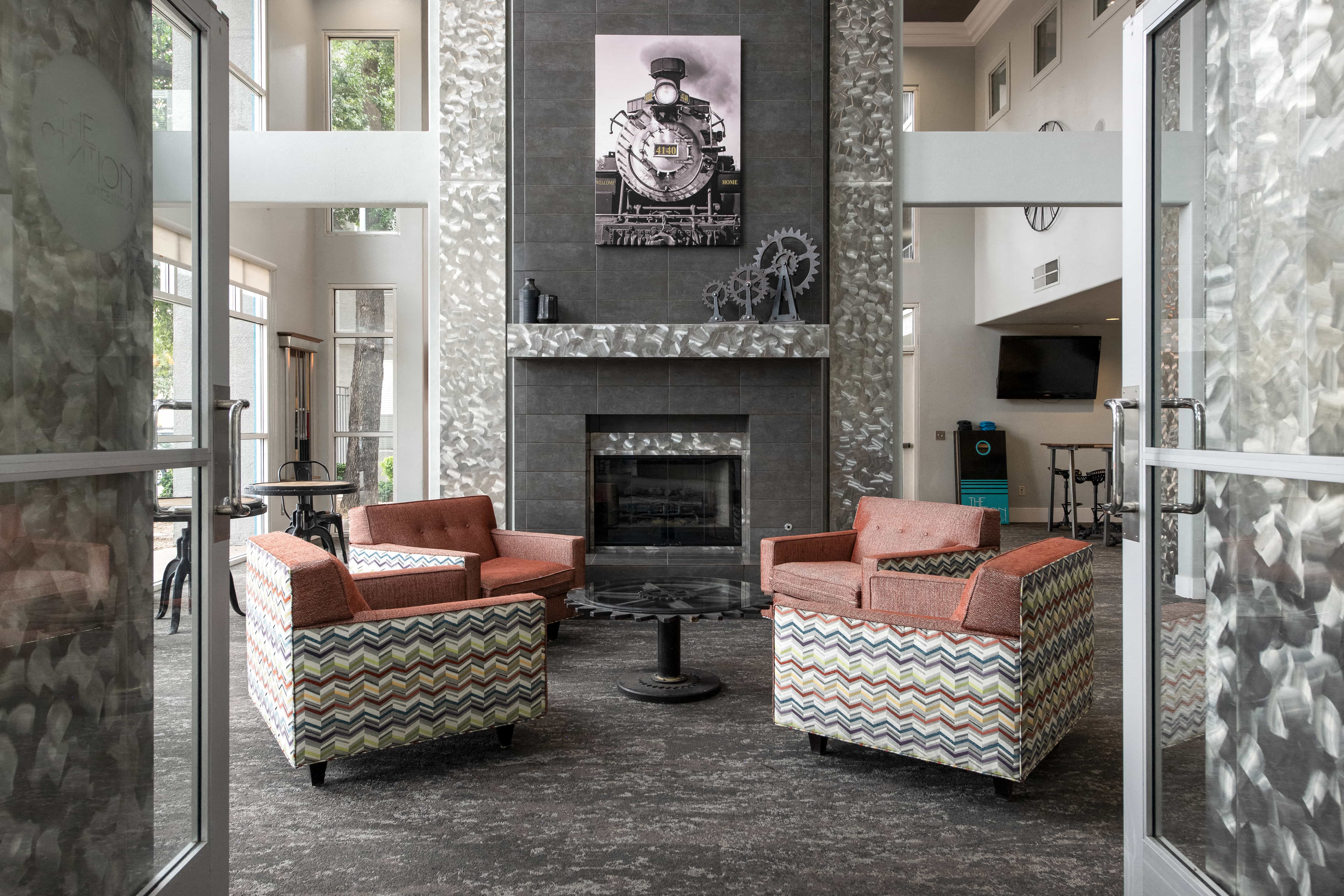 a lobby with couches and chairs and a fireplace