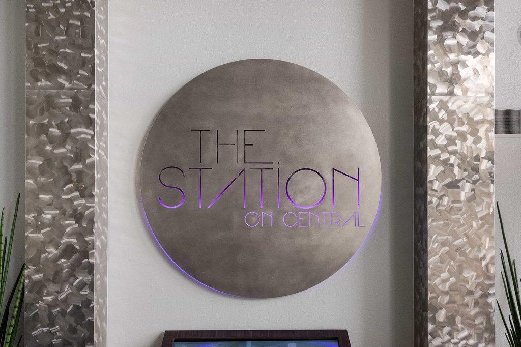 a sign for the station on central hangs on a wall