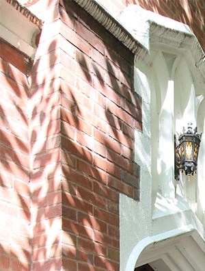 a sidewalk in front of a brick building