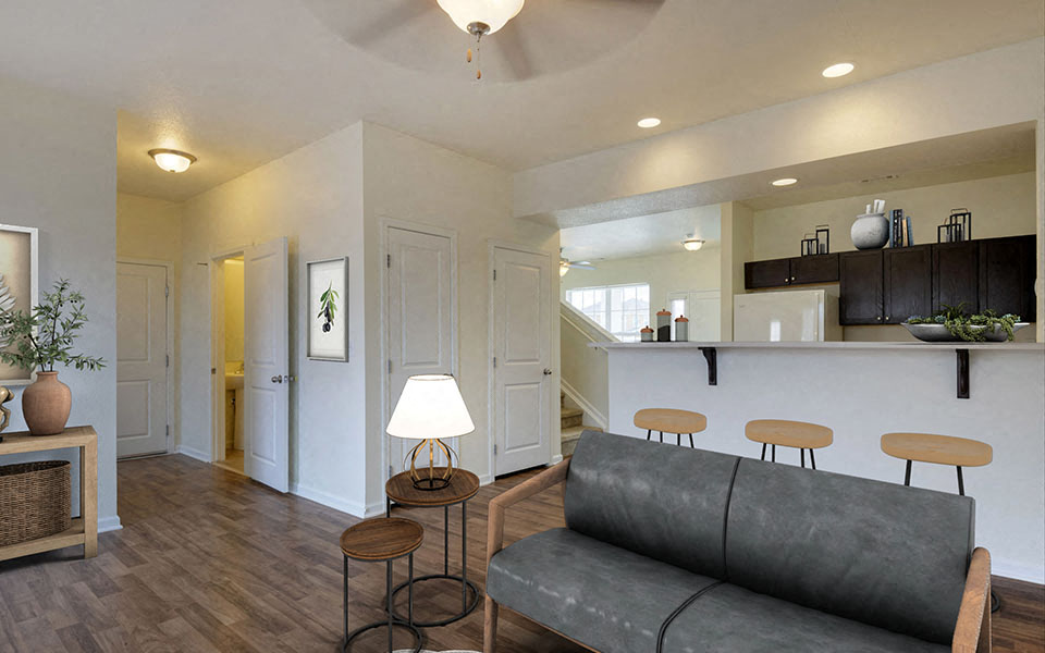 a living room with a couch and a kitchen