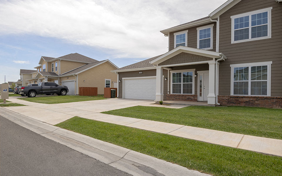 a house with a driveway and a truck parked in front of it
