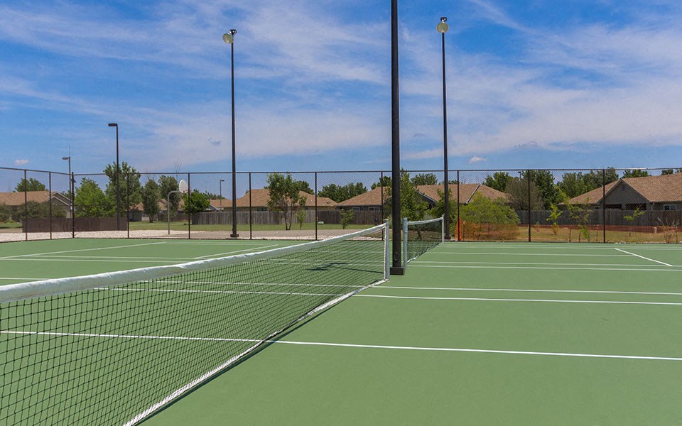 a tennis court with a fence around it
