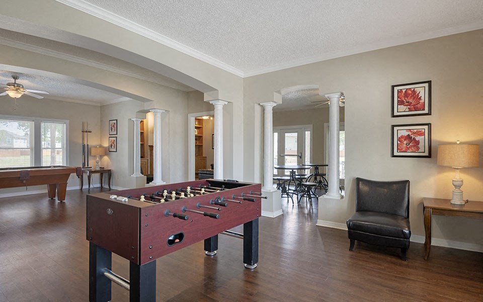 a living room with a pool table    and a dining room