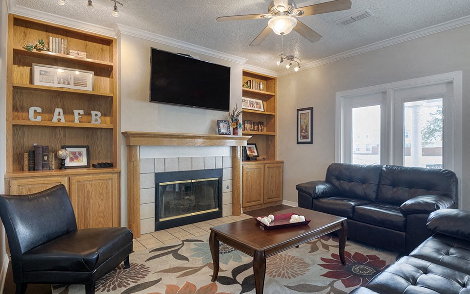 a living room with leather furniture and a fireplace
