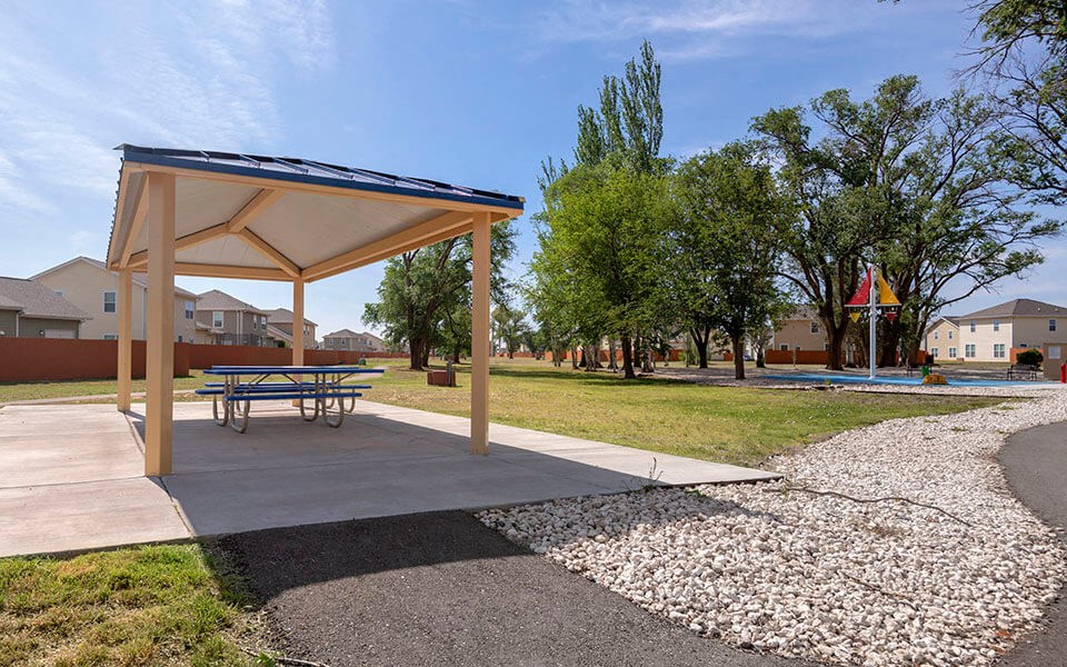 a picnic area with a bench and a picnic table