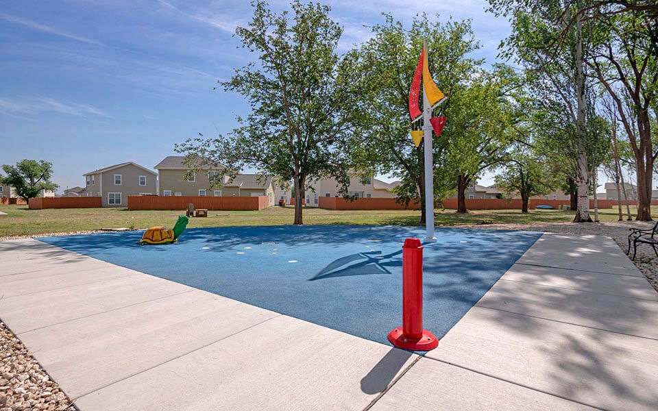 a park with a playground and a flag