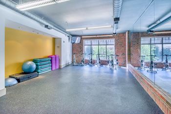 Lofts at Lakeview Apartments - Aerobics studio with spin bikes and classes