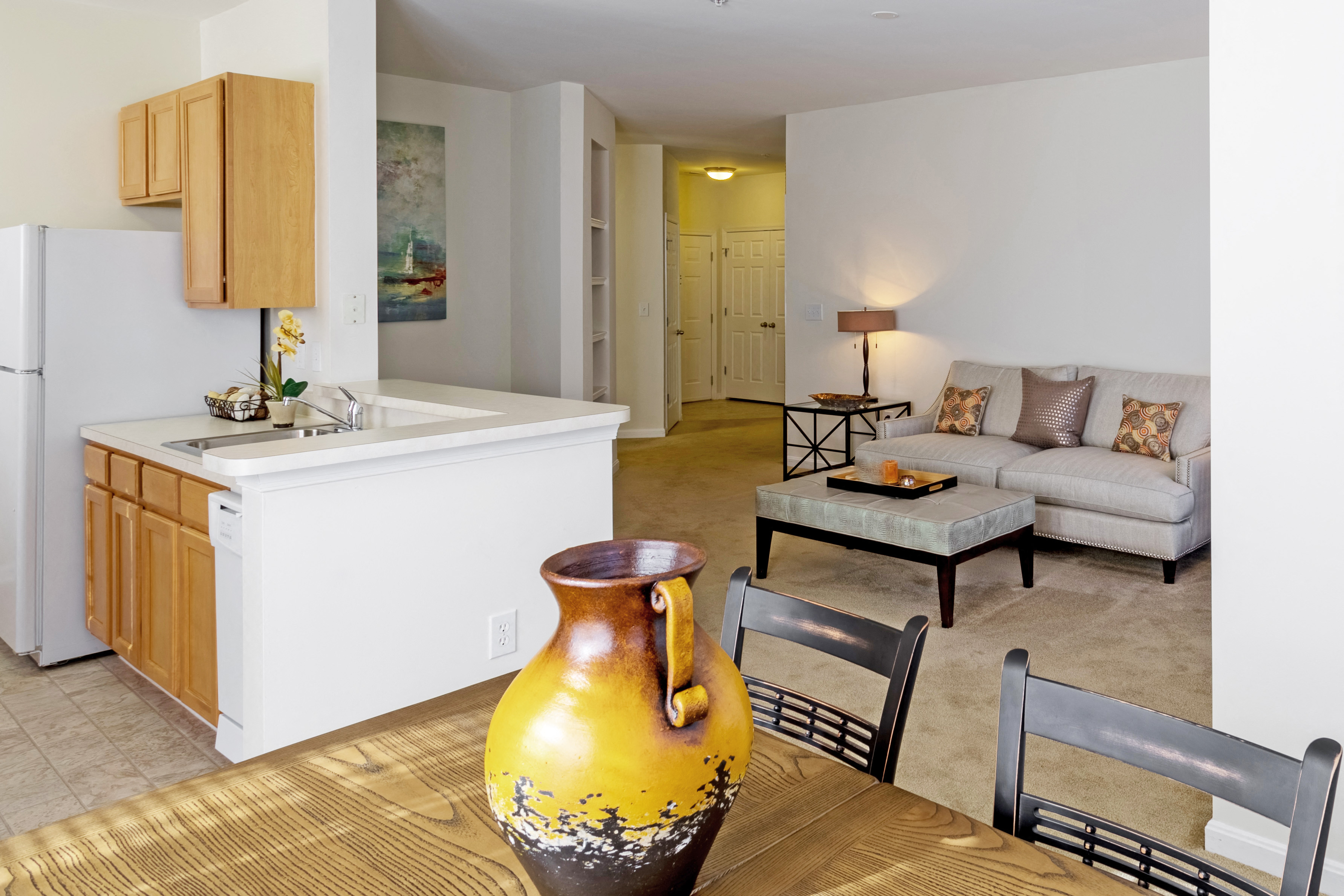 a living room and kitchen with a table and chairs