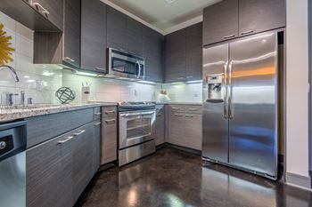 AVANT on Market Center - Open kitchens with stainless steel appliances in select units