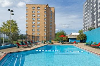 Quality Hill Towers - Resort-style pool with surrounding sun deck and cabana