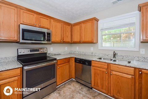 the kitchen has ample counter space and stainless steel appliances