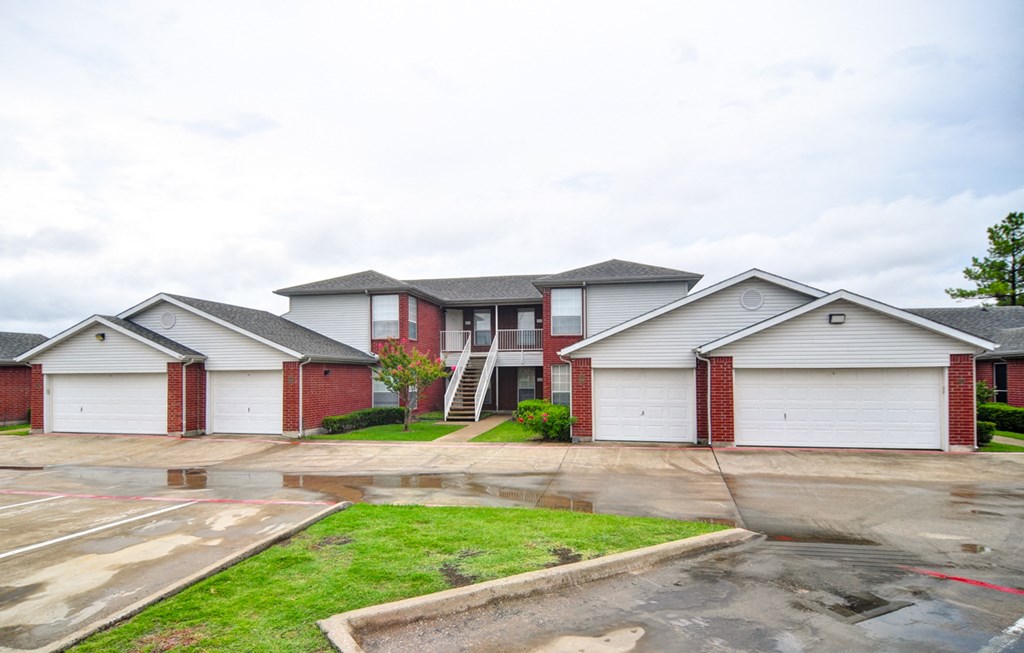 a row of houses with white siding on a rainy day