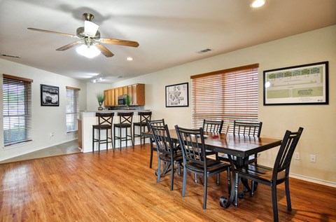 the dining room and kitchen of a home with a table and chairs