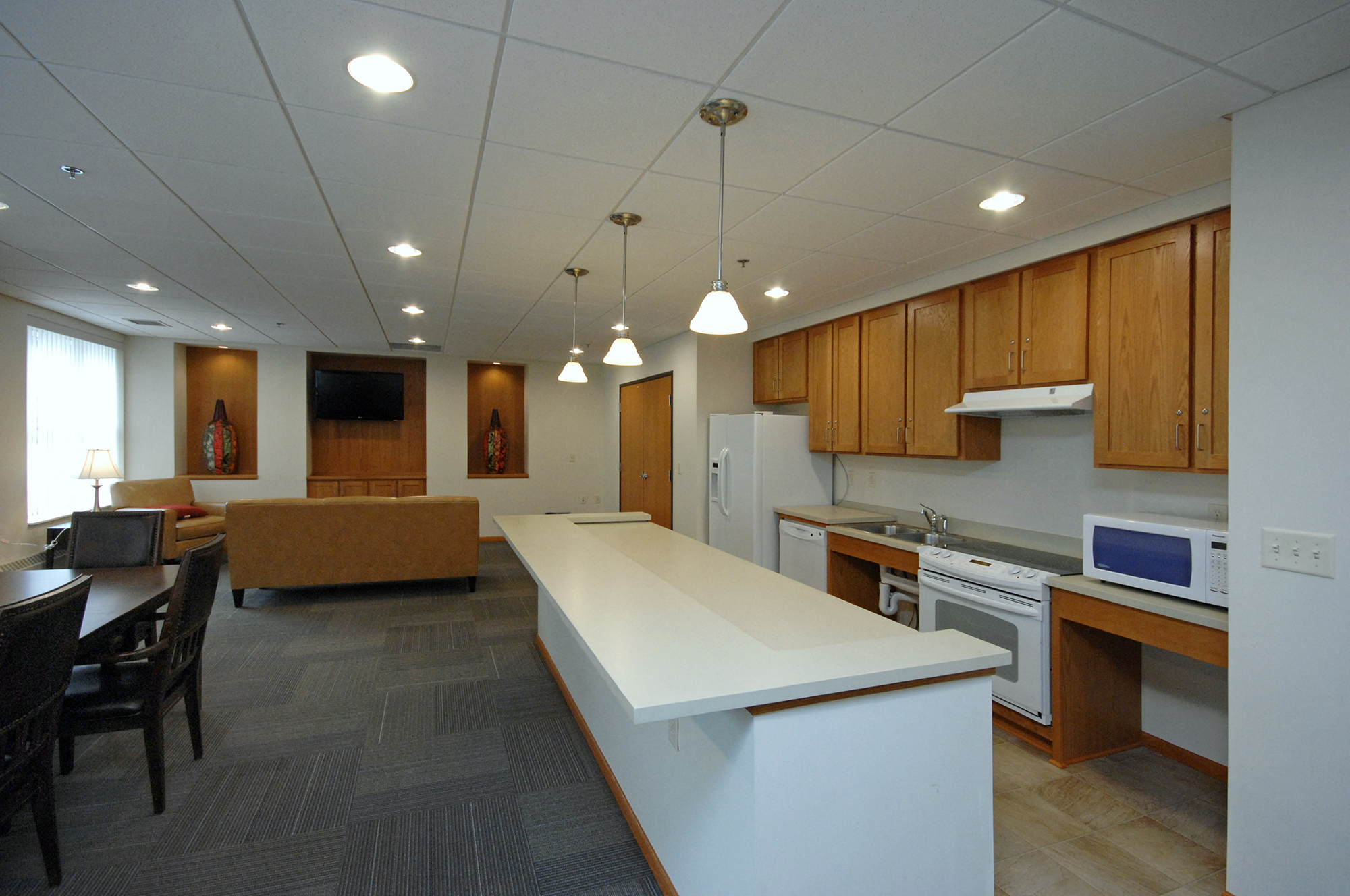a kitchen with an island and a living room