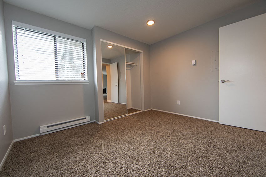 a room with a carpeted floor and a window