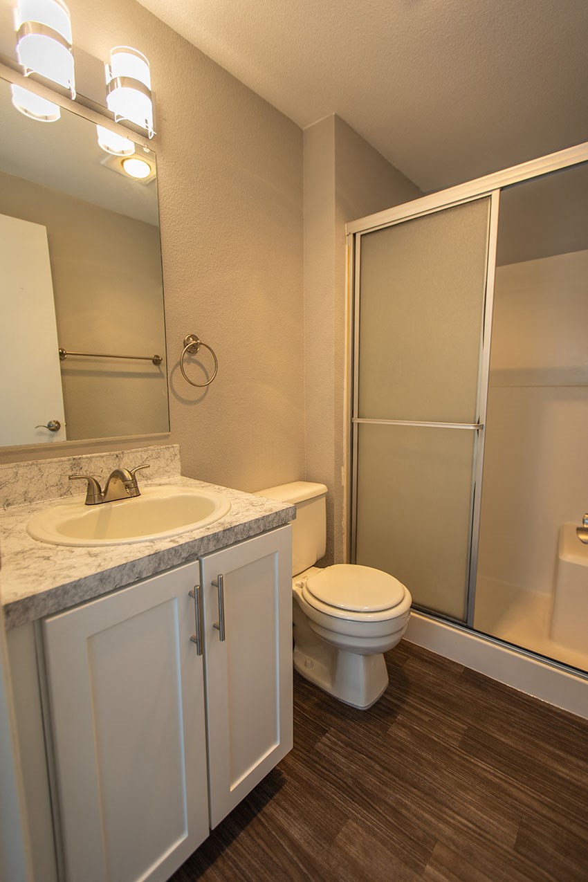 a bathroom with a toilet sink and shower