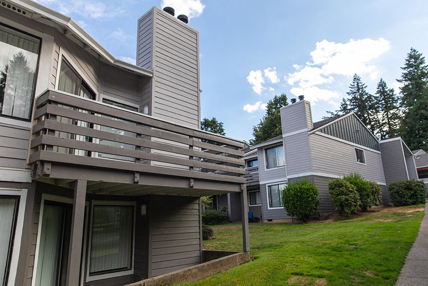 a view of a house with a balcony and a yard