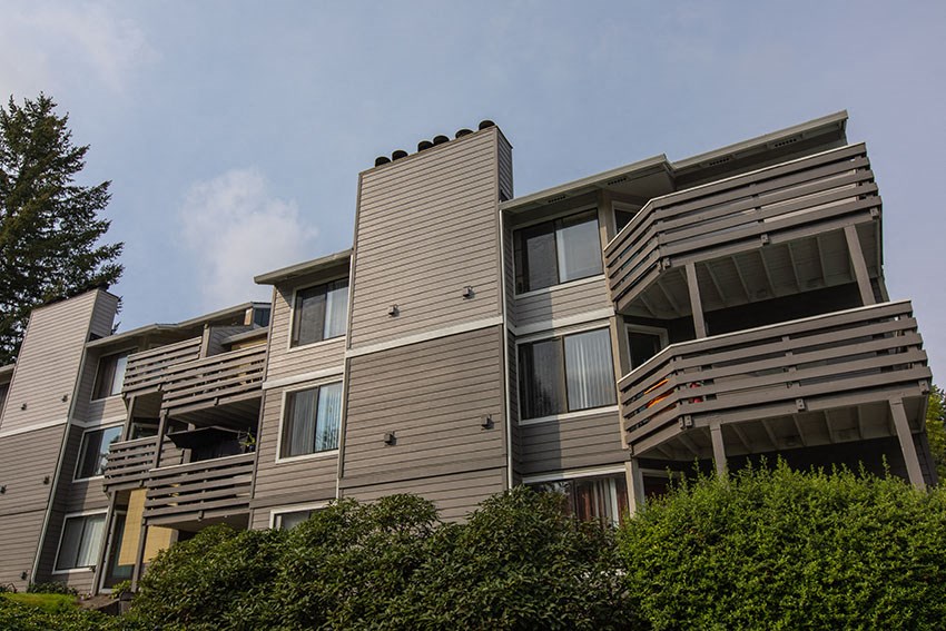 a large apartment building with a blue sky in the background